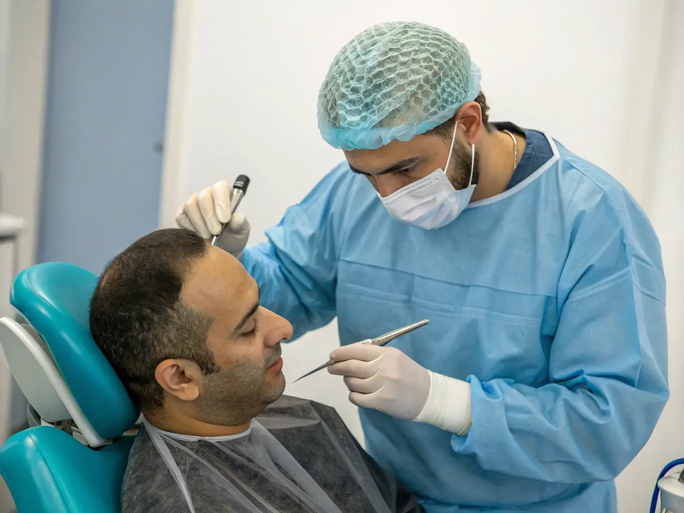 A close-up shot of a patient's scalp undergoing a DHI hair transplant procedure at Hair Art Clinics, showcasing the precision and care involved.